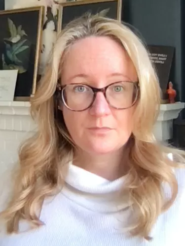 Katherine Collins sitting at a desk